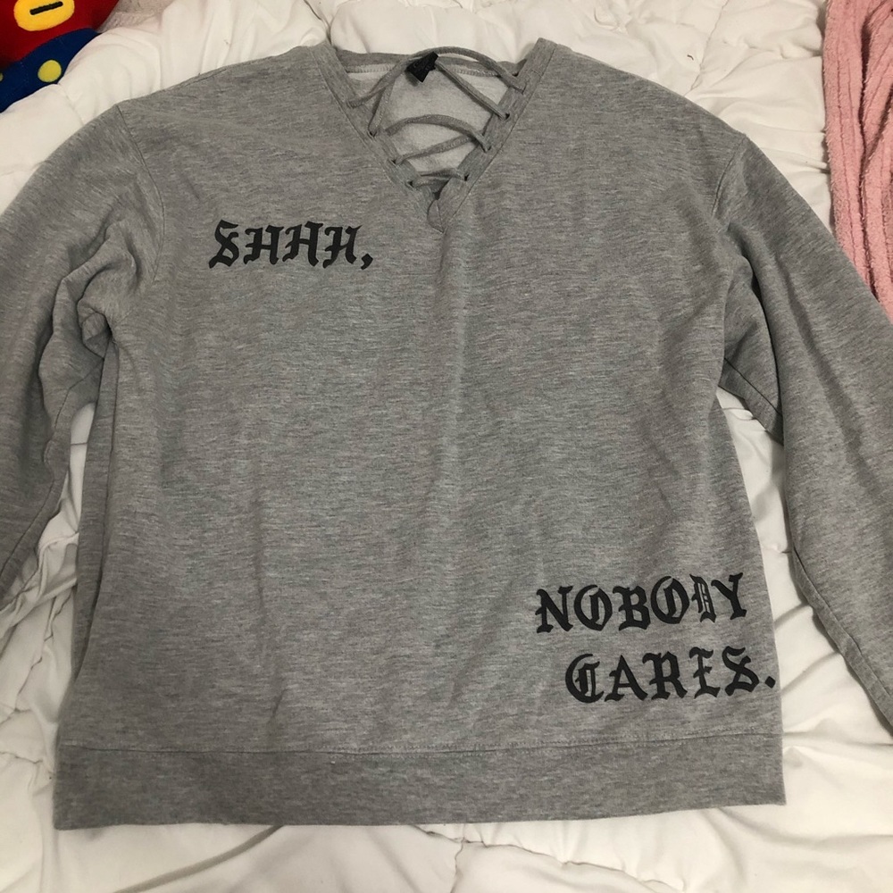 Grey sweater w/ quote and stringy v-neck
